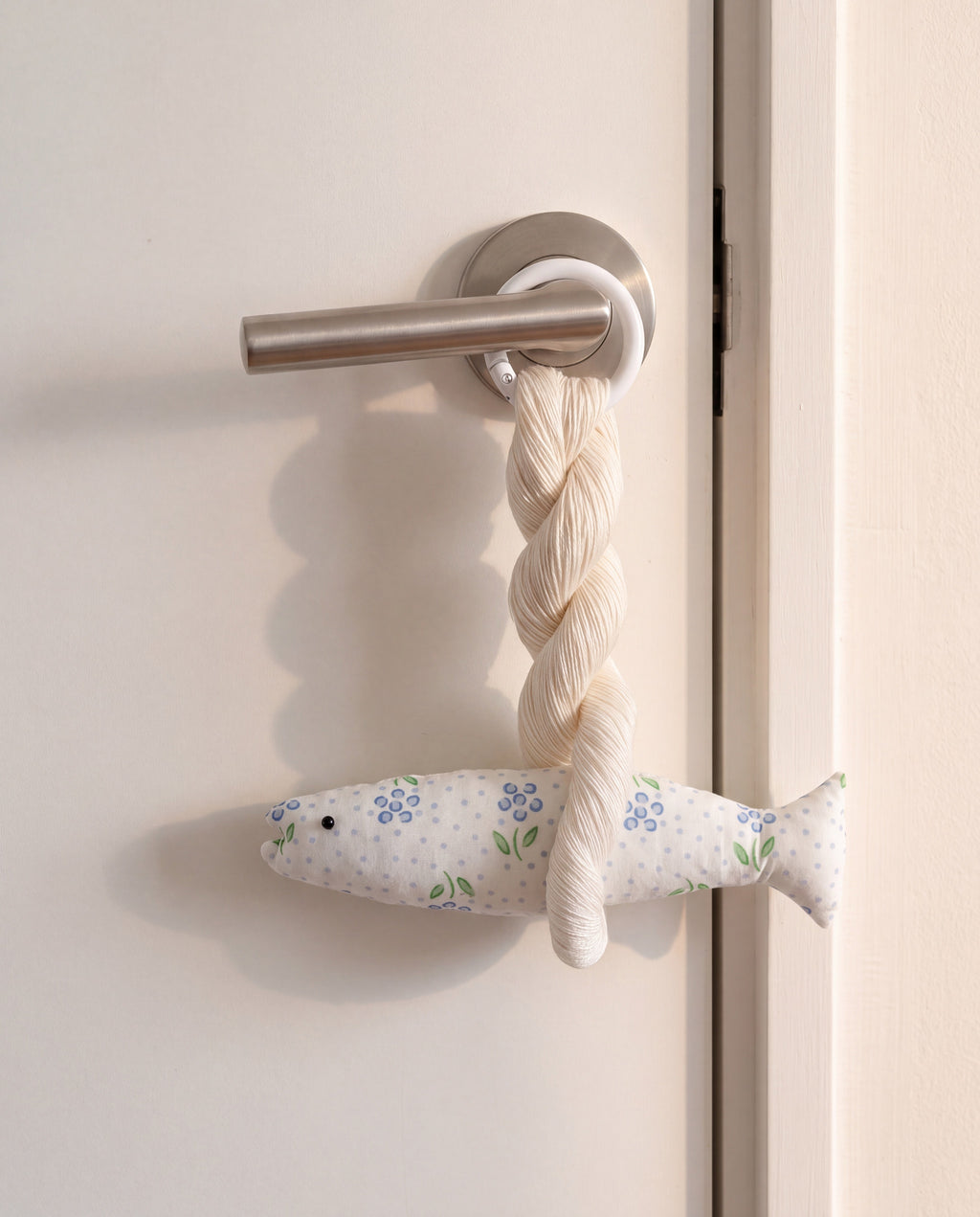Blair good luck pollack ornament by lemonbaseball livingclub, ring clasp closed around a door lever