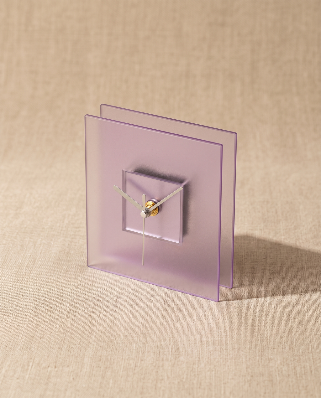 Block clock by APTONE in frosted purple, three-quarter view on natural linen