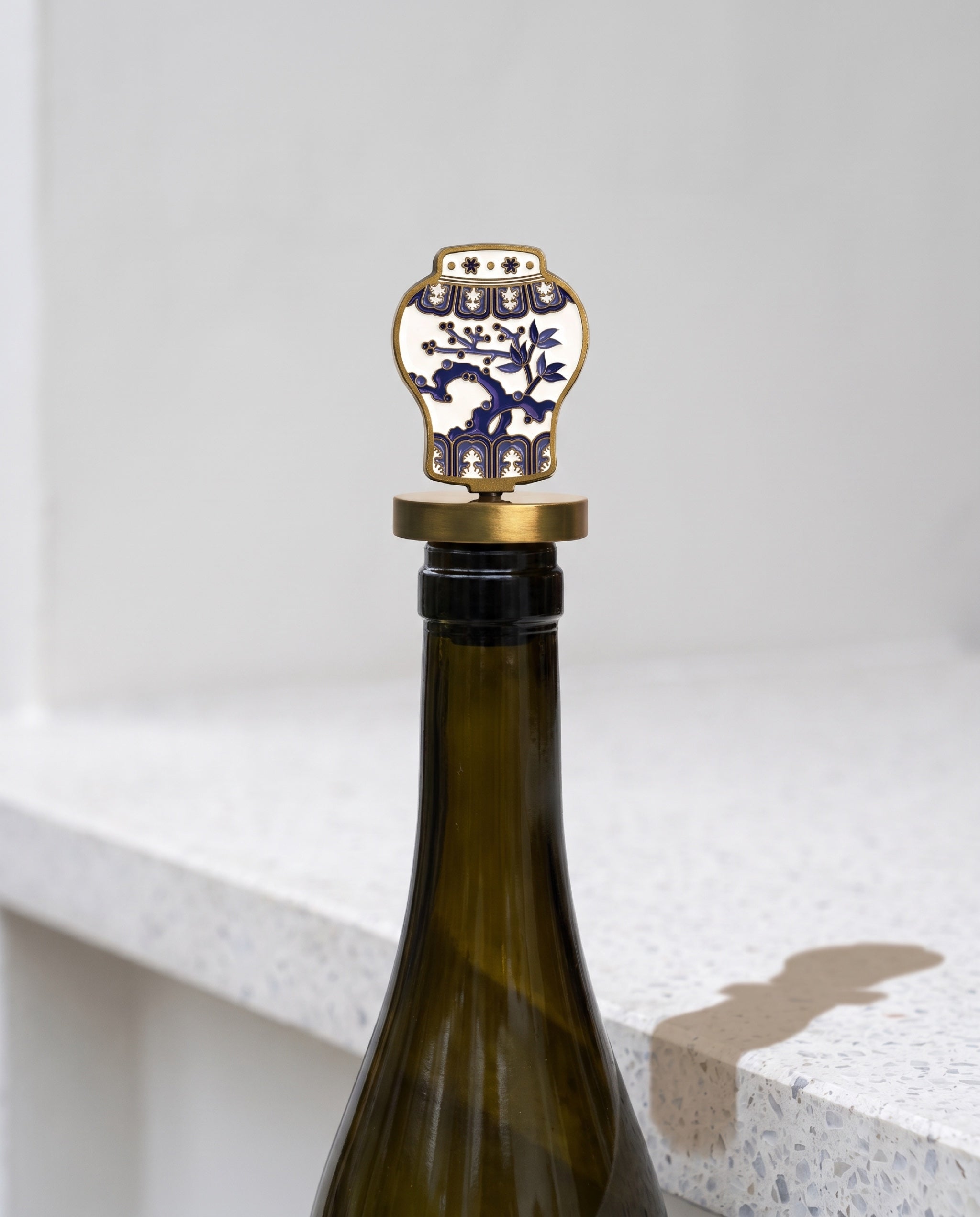 Celadon in the house wine stopper by Mimidar, seated in the neck of an opened wine bottle