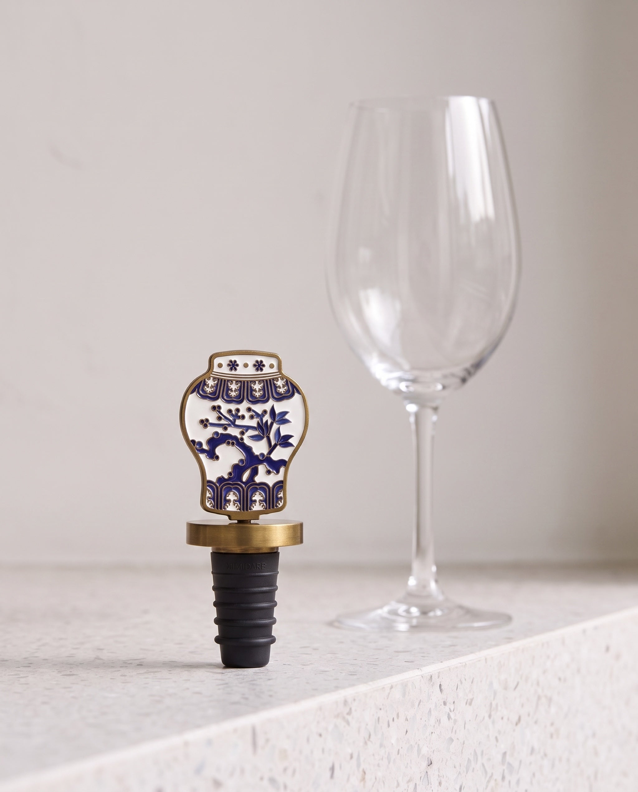 Celadon in the house wine stopper by Mimidar, scale reference beside a wine glass