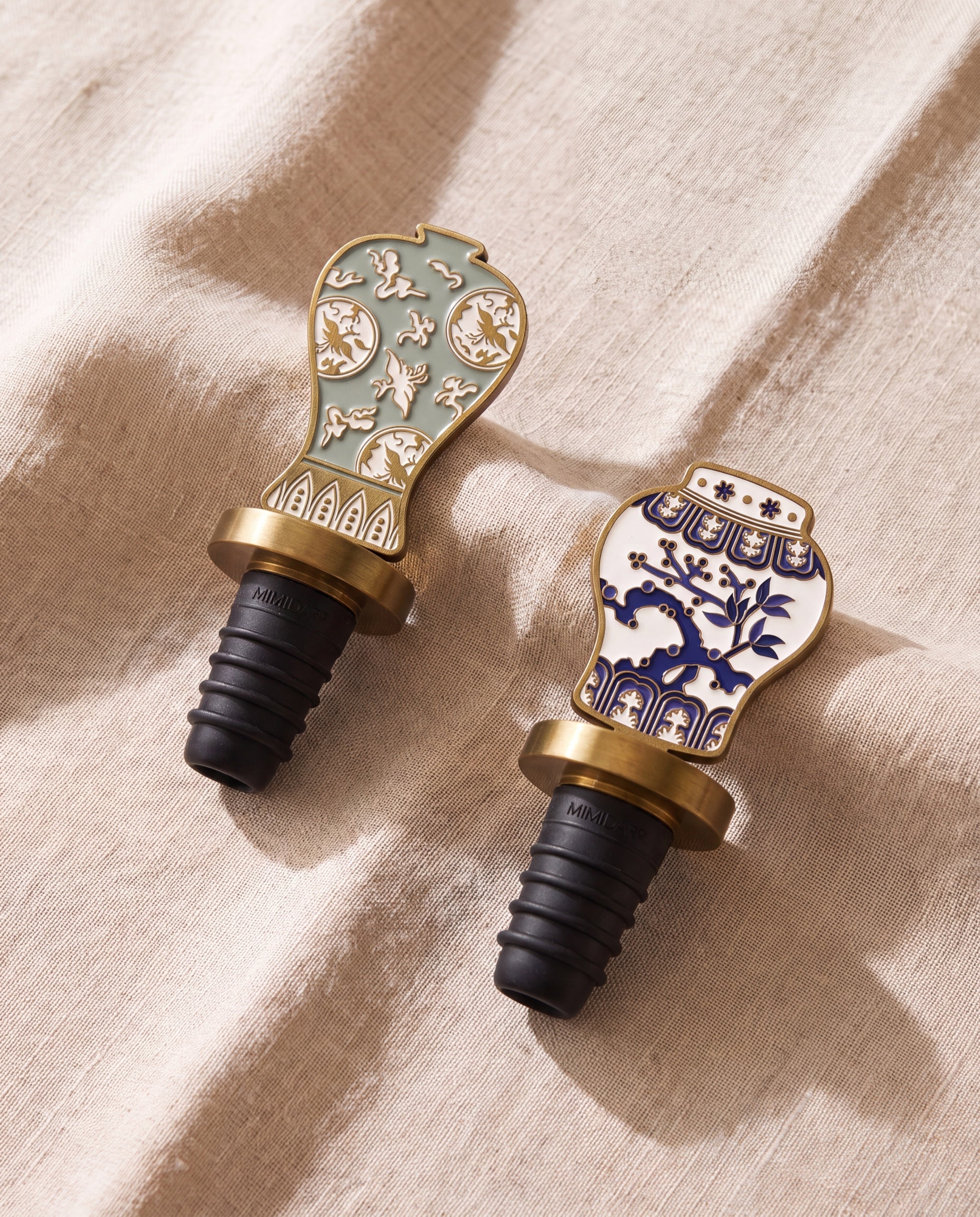 Celadon in the house wine stopper by Mimidar, both enamel designs on beige linen