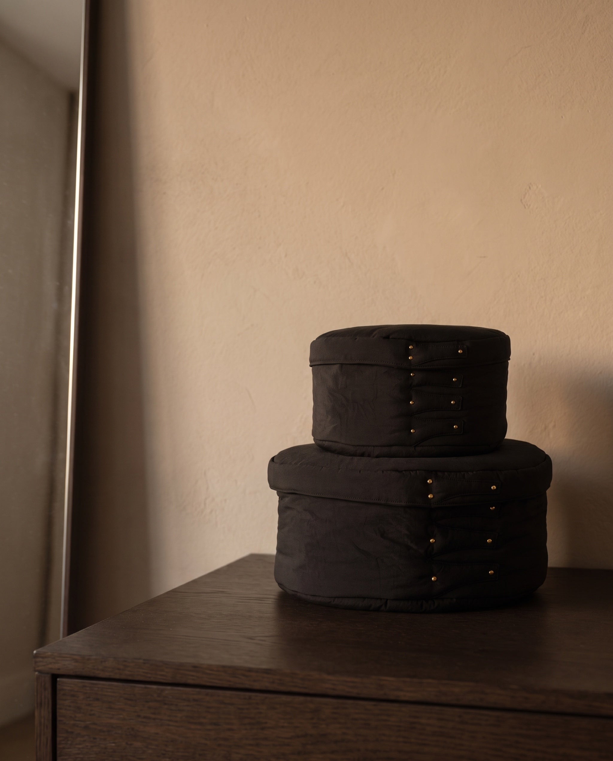 Cloud shaker box, black by life&COLLECT — in its room, on a bedroom dresser at dusk