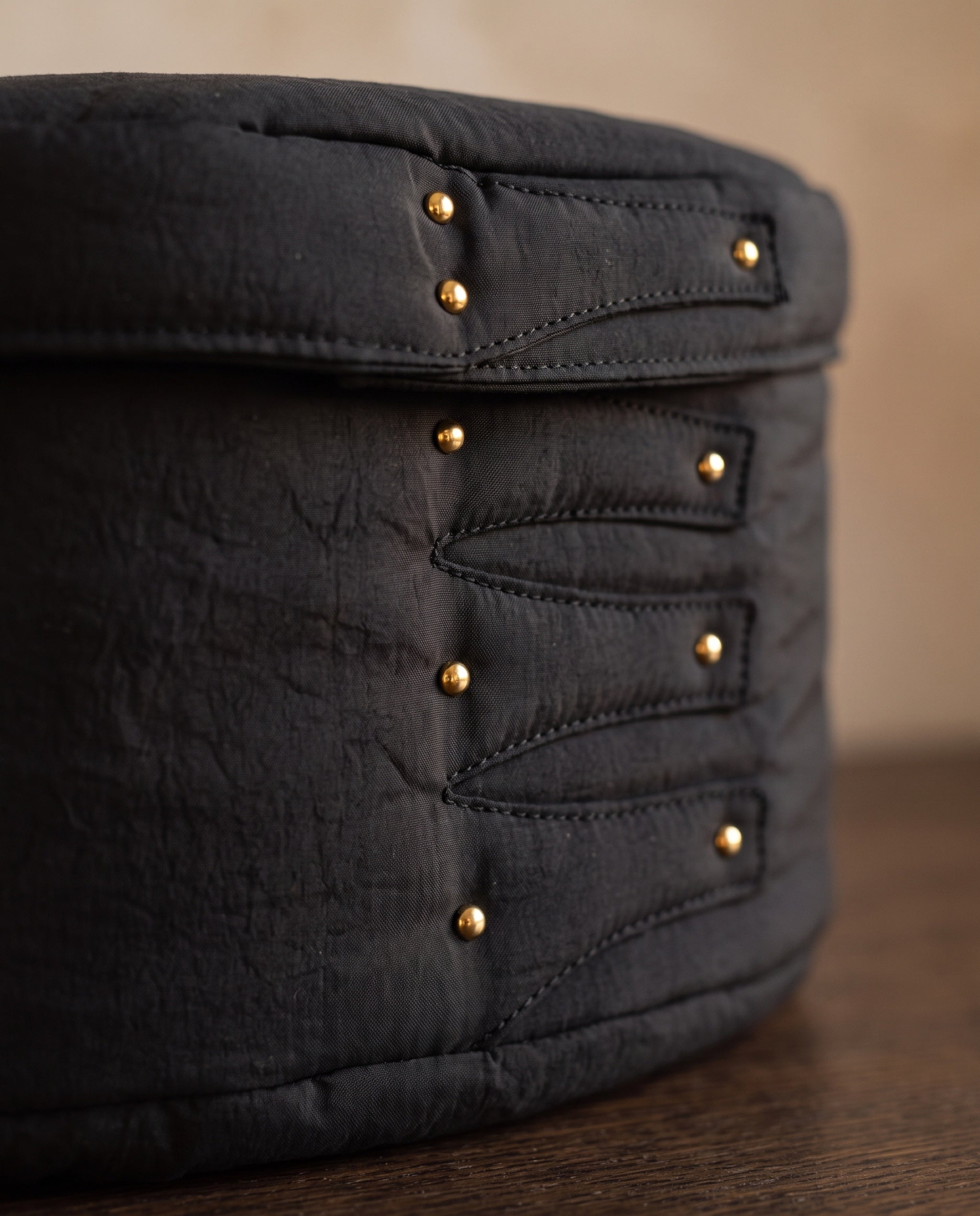 Cloud shaker box, black by life&COLLECT — material detail: forked stitch tabs and gold ball studs