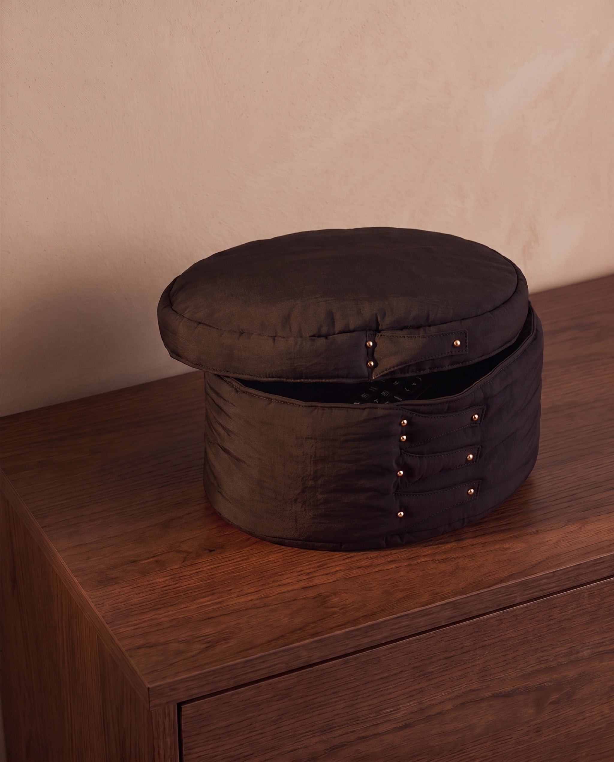 Cloud shaker box, black by life&COLLECT — lid resting askew, a remote just visible inside