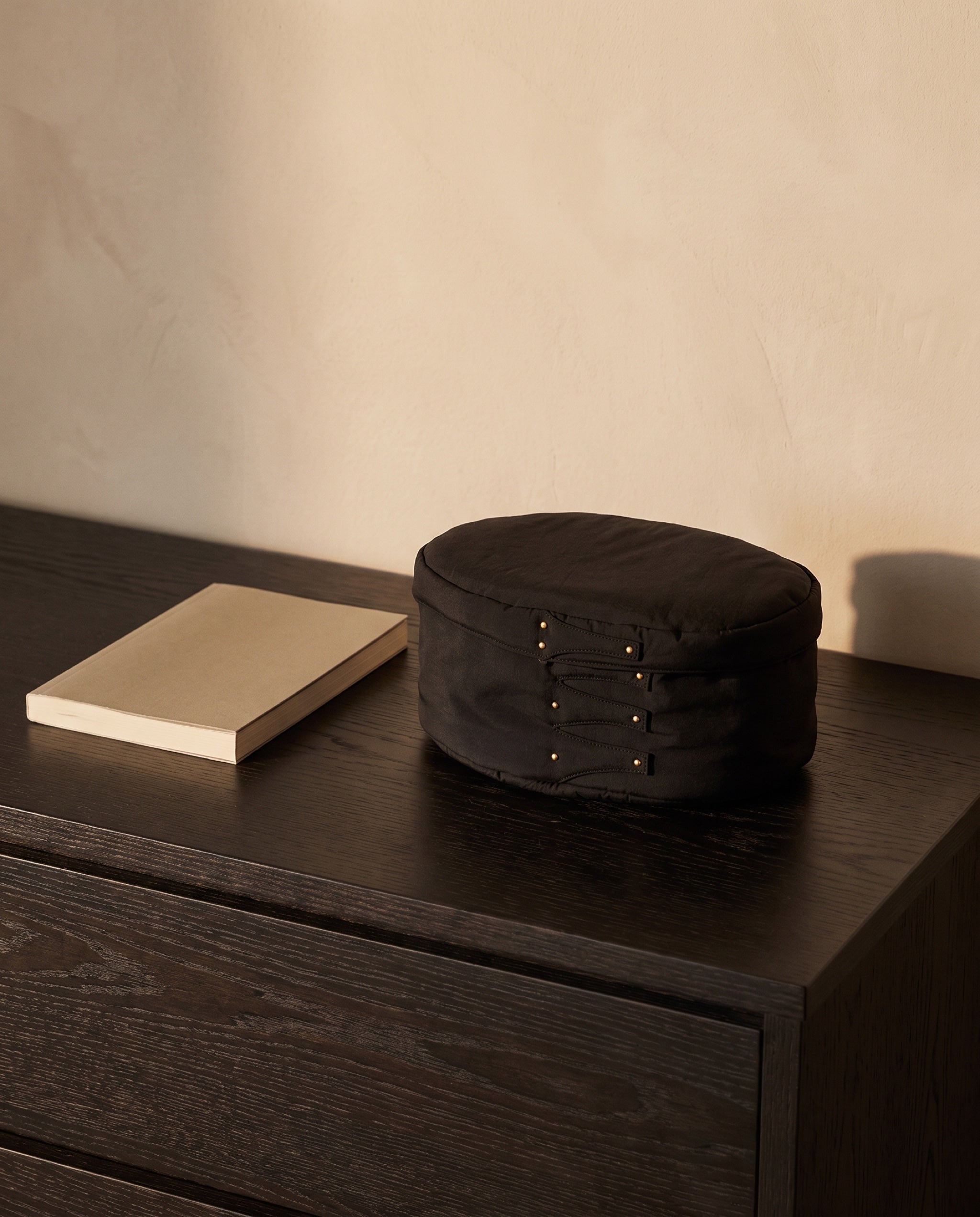 Cloud shaker box, black by life&COLLECT — scale reference next to a paperback