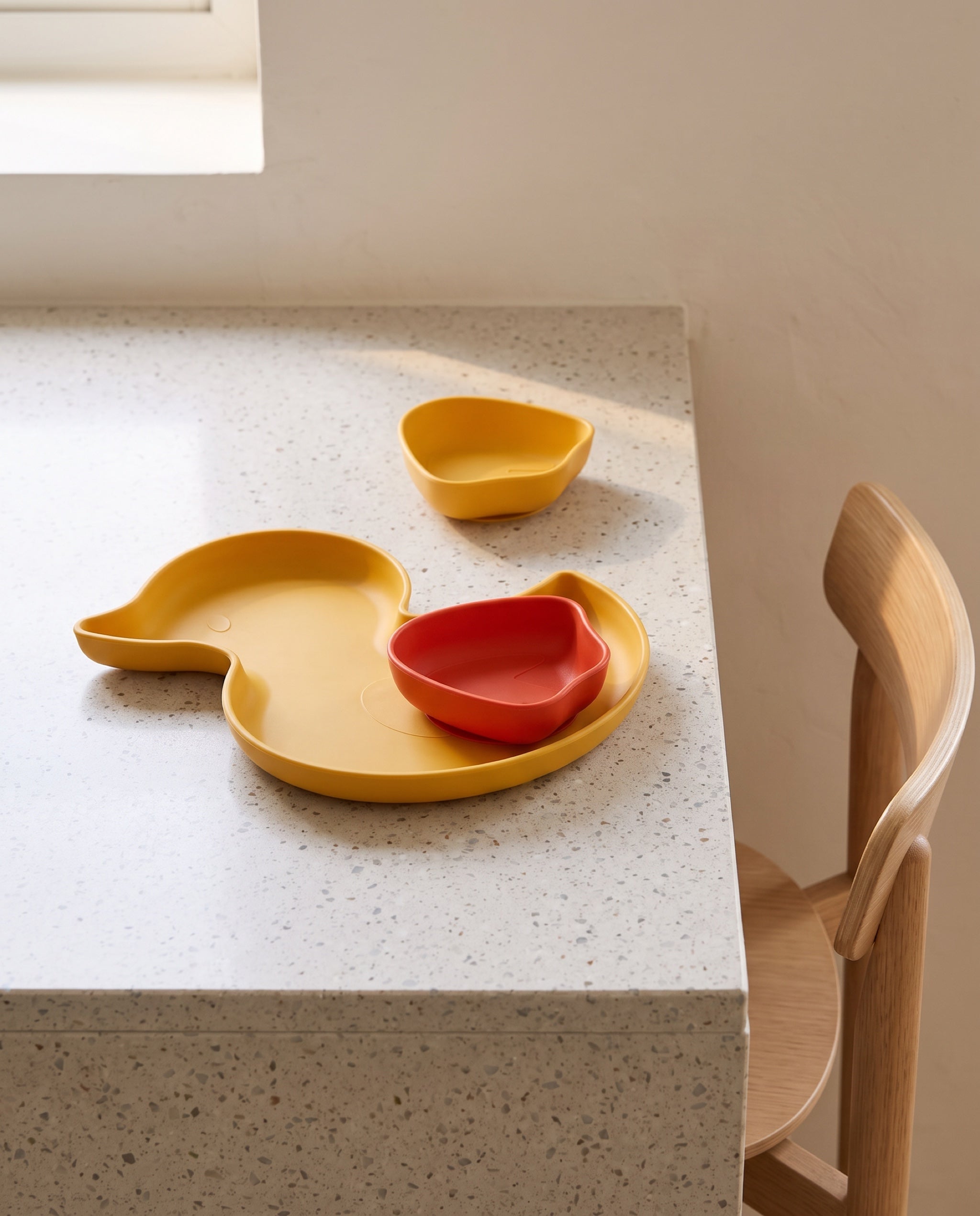 Ducky plate and Webby bowls by ceriz, on a terrazzo kitchen counter