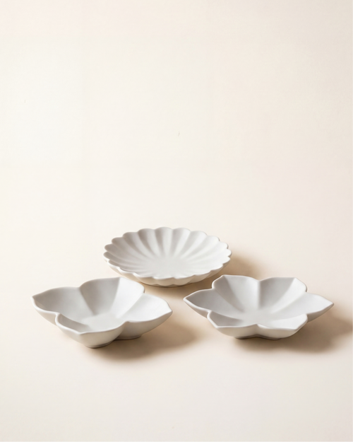 Flower plate set by Mujagi, hand-formed Korean baekja porcelain in three petal forms on a hanji-cream backdrop