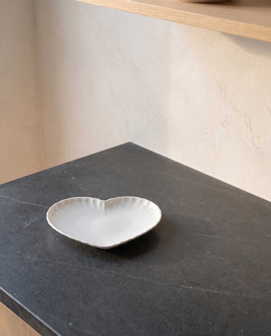 Heart plate by Mujagi, on a charcoal soapstone kitchen counter
