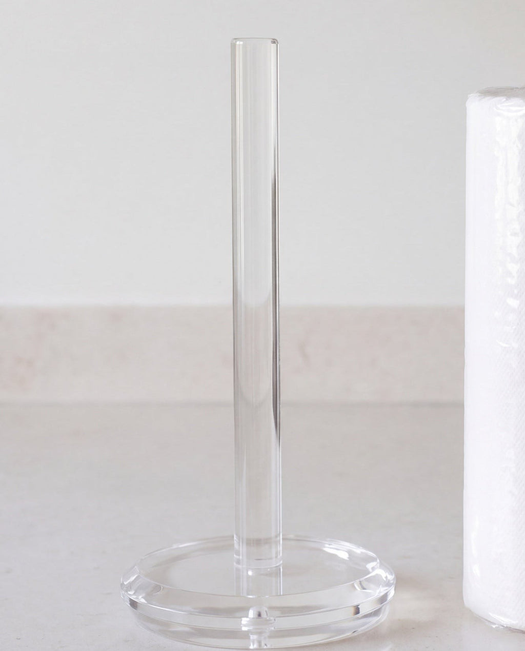 Klir paper towel holder by APTONE, shown beside a full kitchen roll for scale