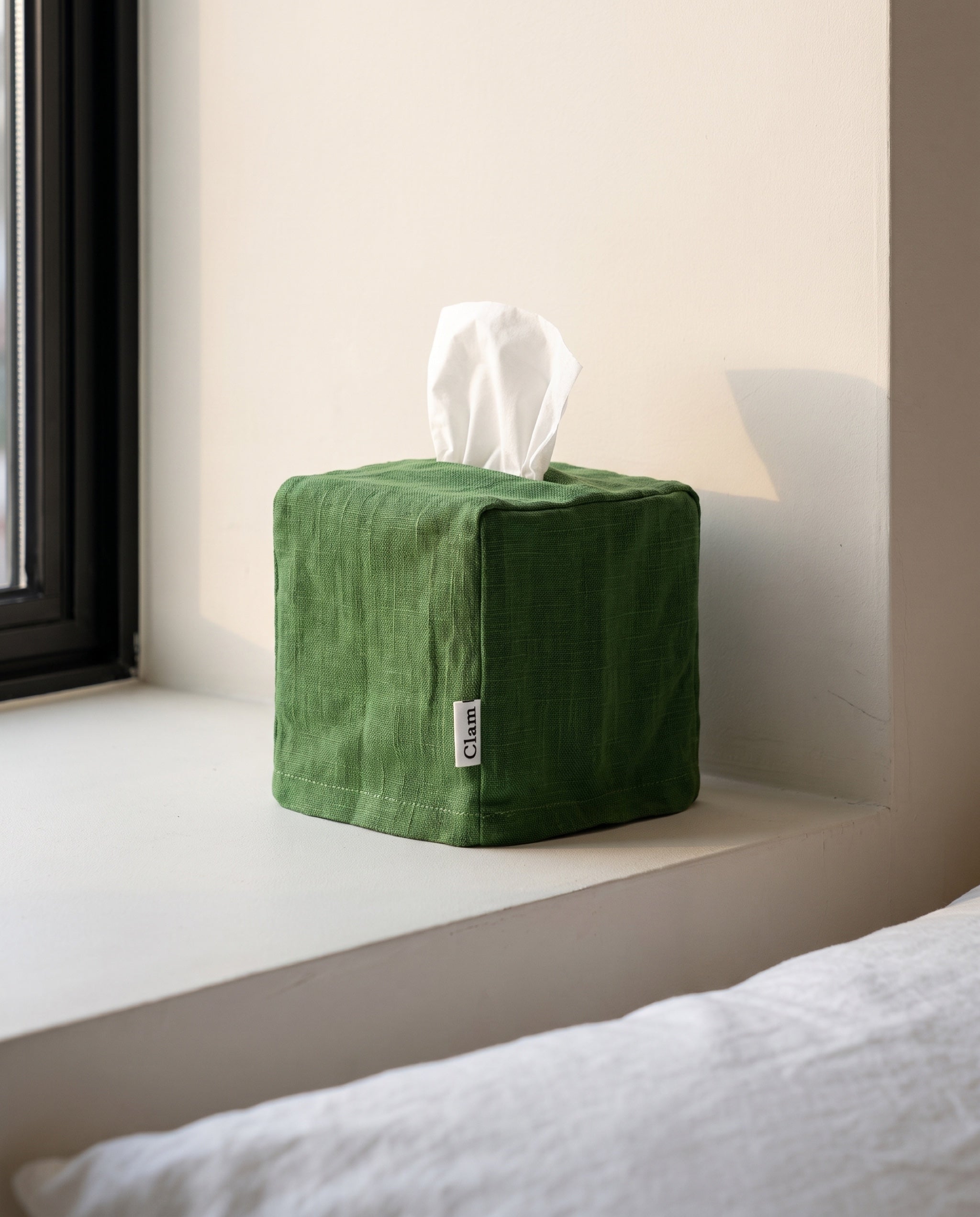 Linen tissue cover by Clam, on a bedroom window sill at the end of the day