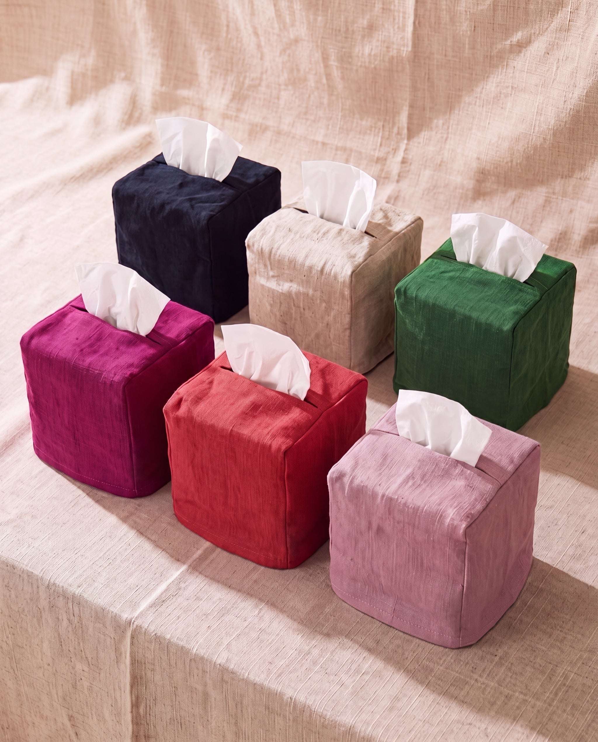 Linen tissue cover by Clam, all six colorways together on beige linen