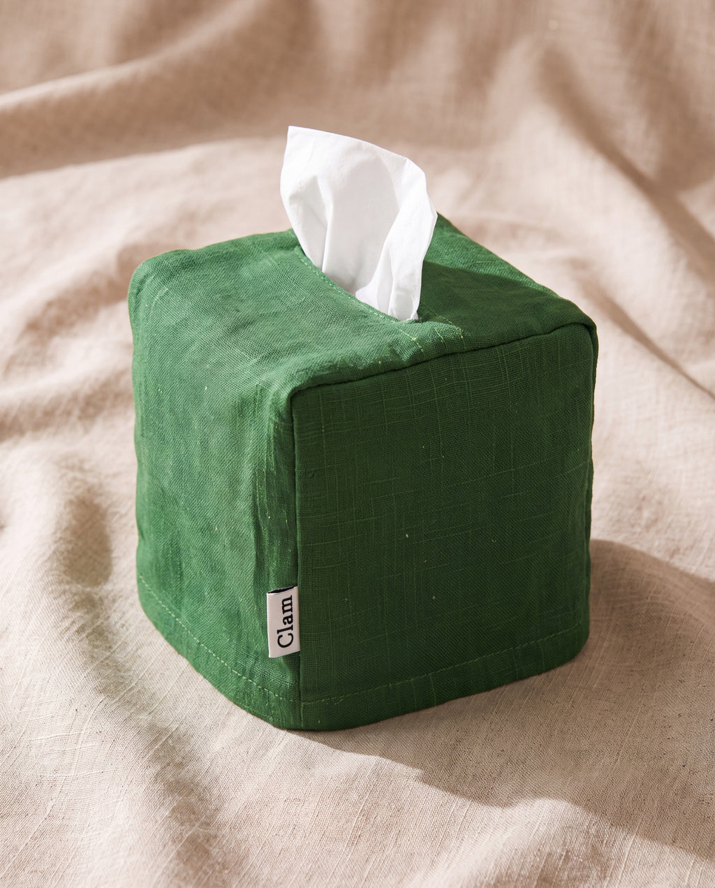 Linen tissue cover by Clam, grass green slubby linen on a beige linen backdrop