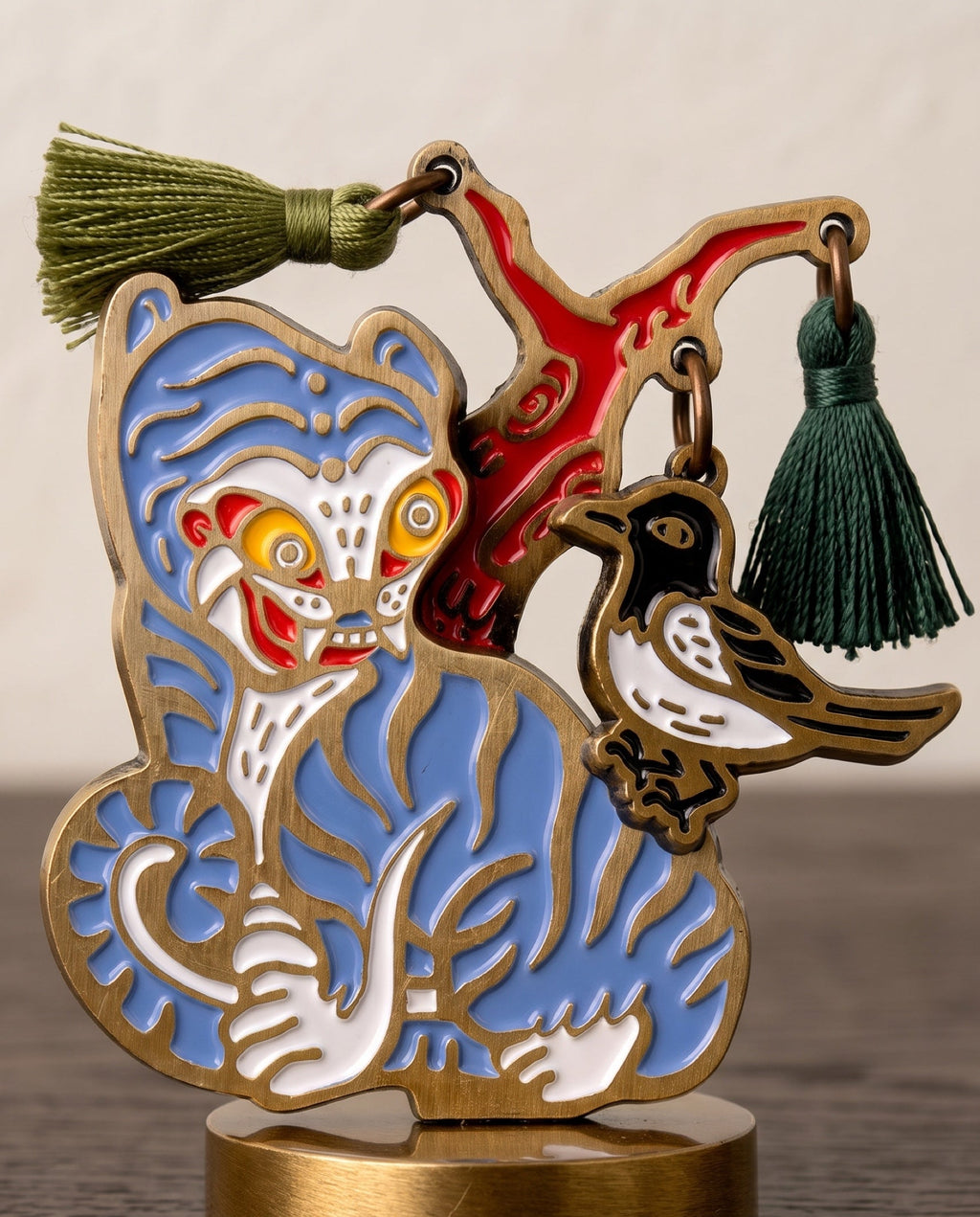 Magpie and tiger wine stopper by Mimidar, raised brass linework and enamel in close-up