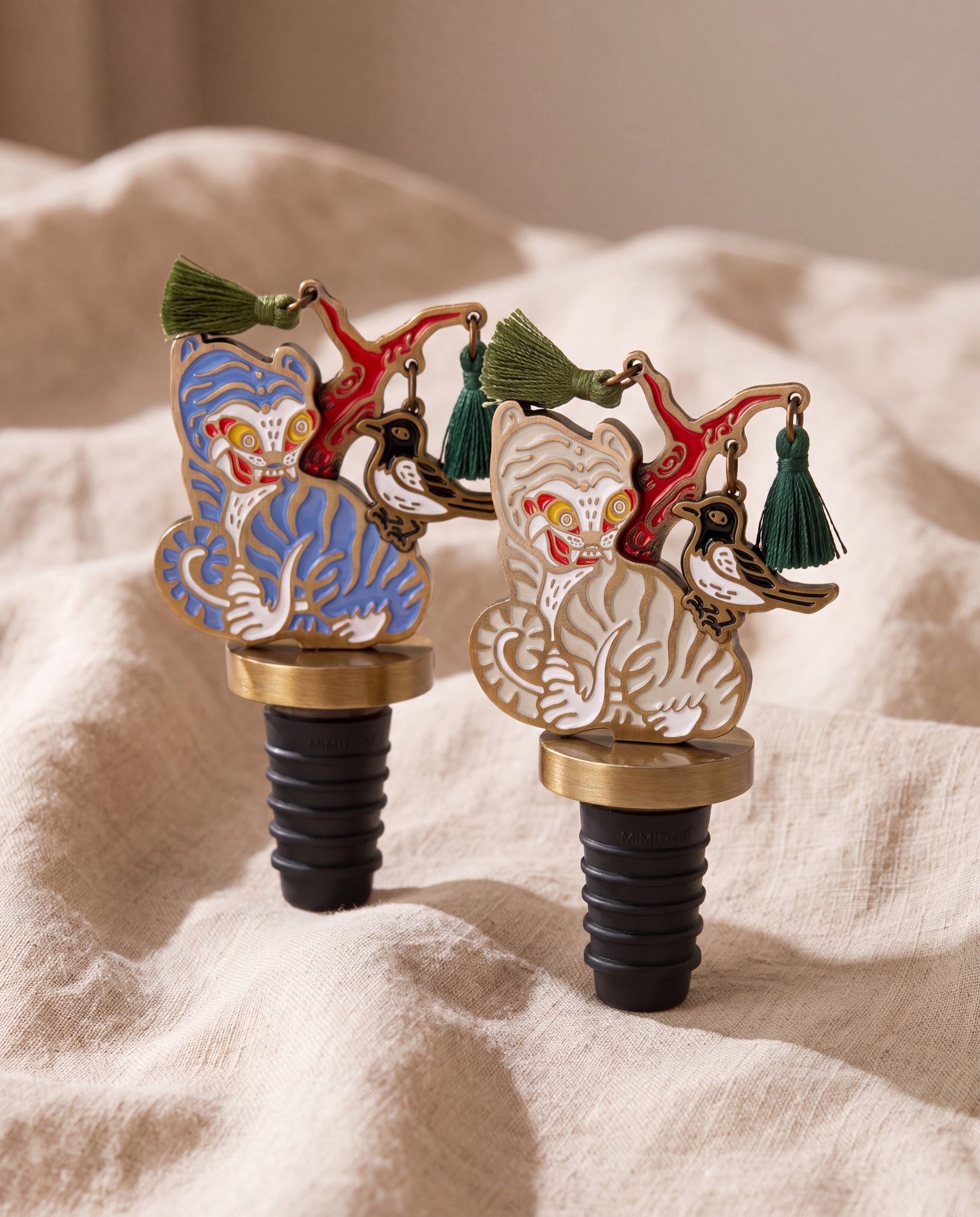 Magpie and tiger wine stopper by Mimidar, both colorways on beige linen