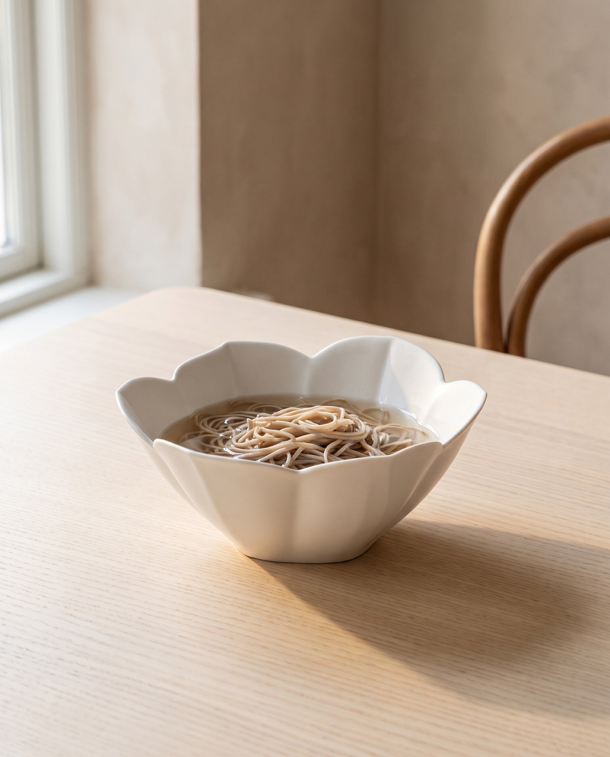 Petal bowl by Mujagi, holding cold noodles in broth well below the rim