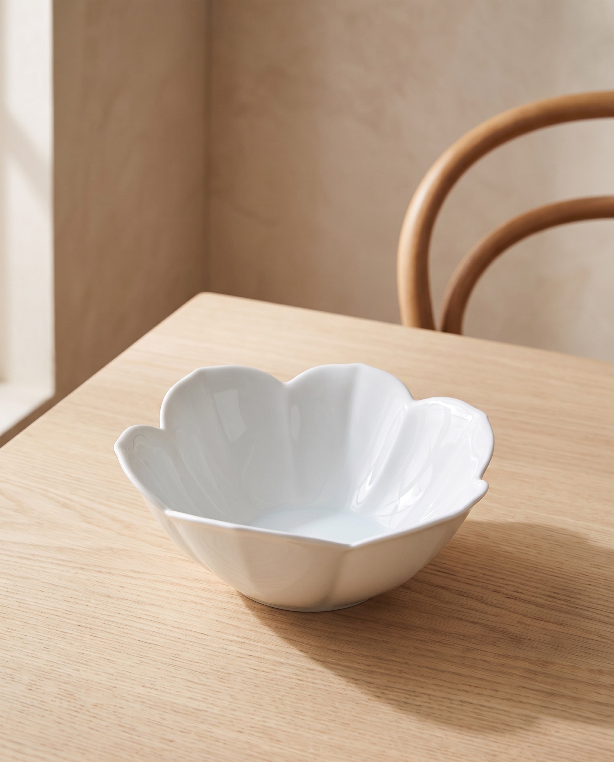 Petal bowl by Mujagi, the gloss finish on a pale ash dining table