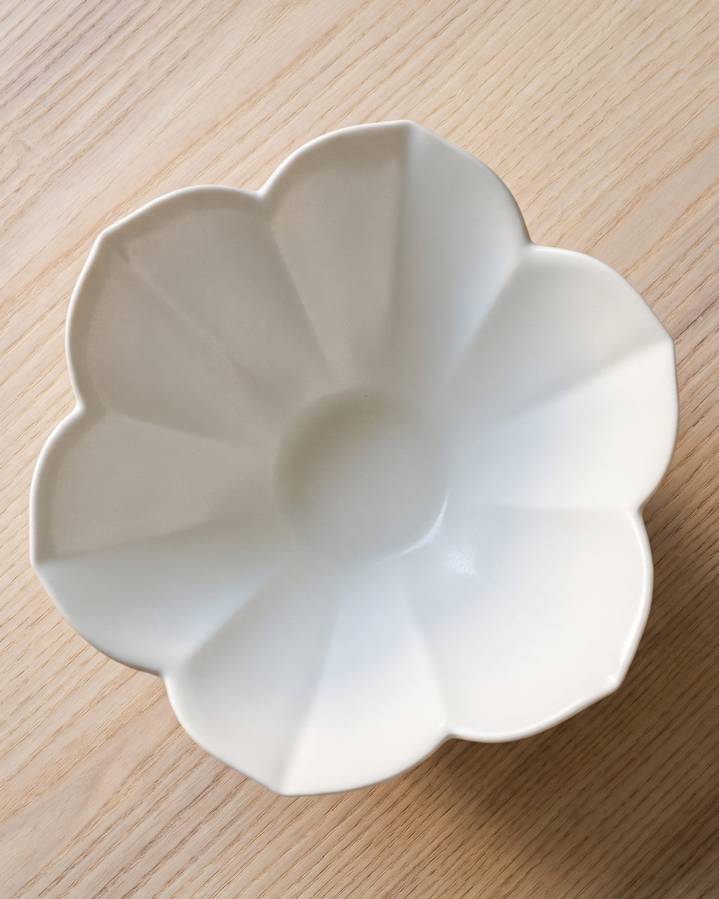 Petal bowl by Mujagi, seen from directly above on a pale ash table