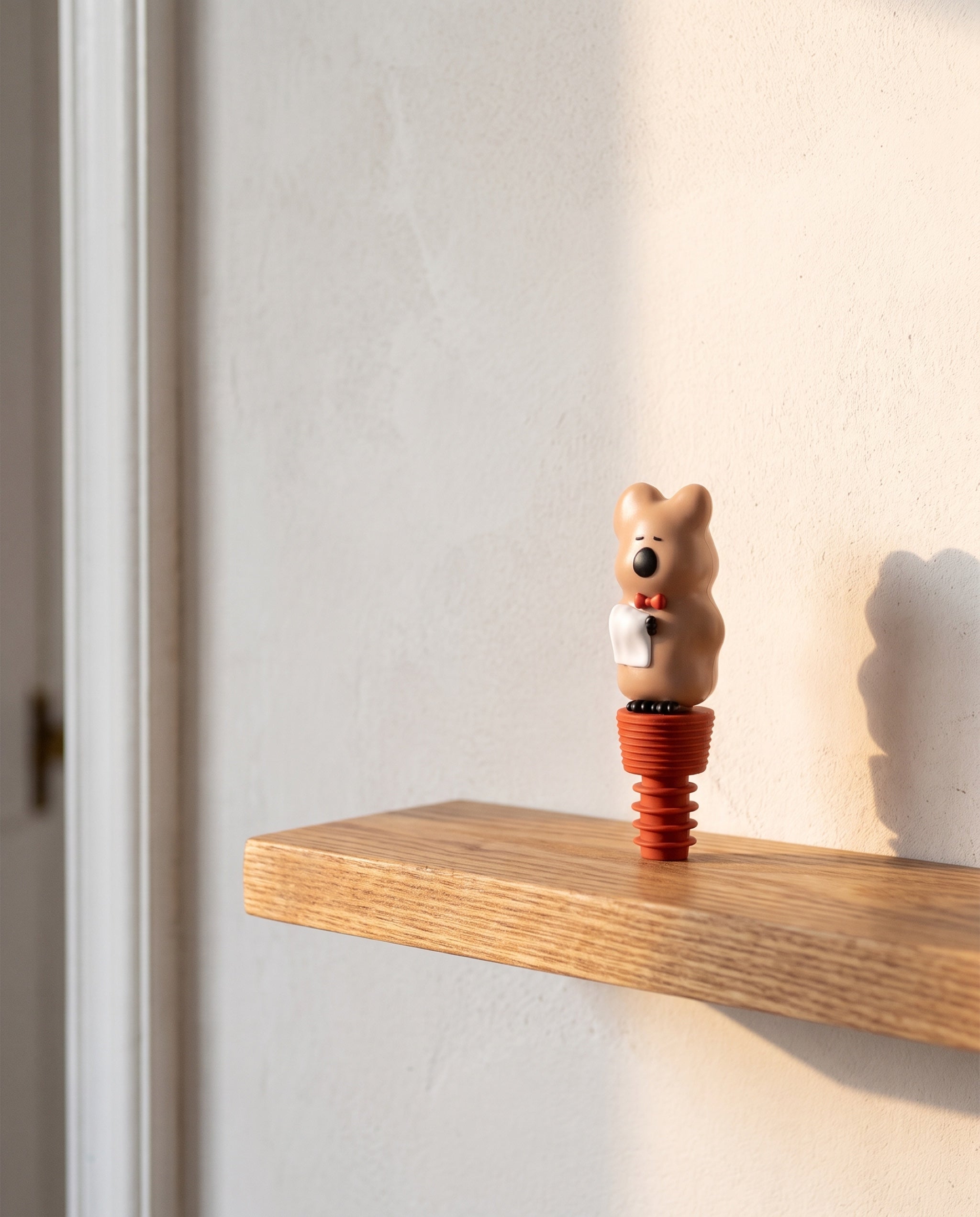 Quokka wine stopper by Dinotaeng, on the shelf where the bottles live