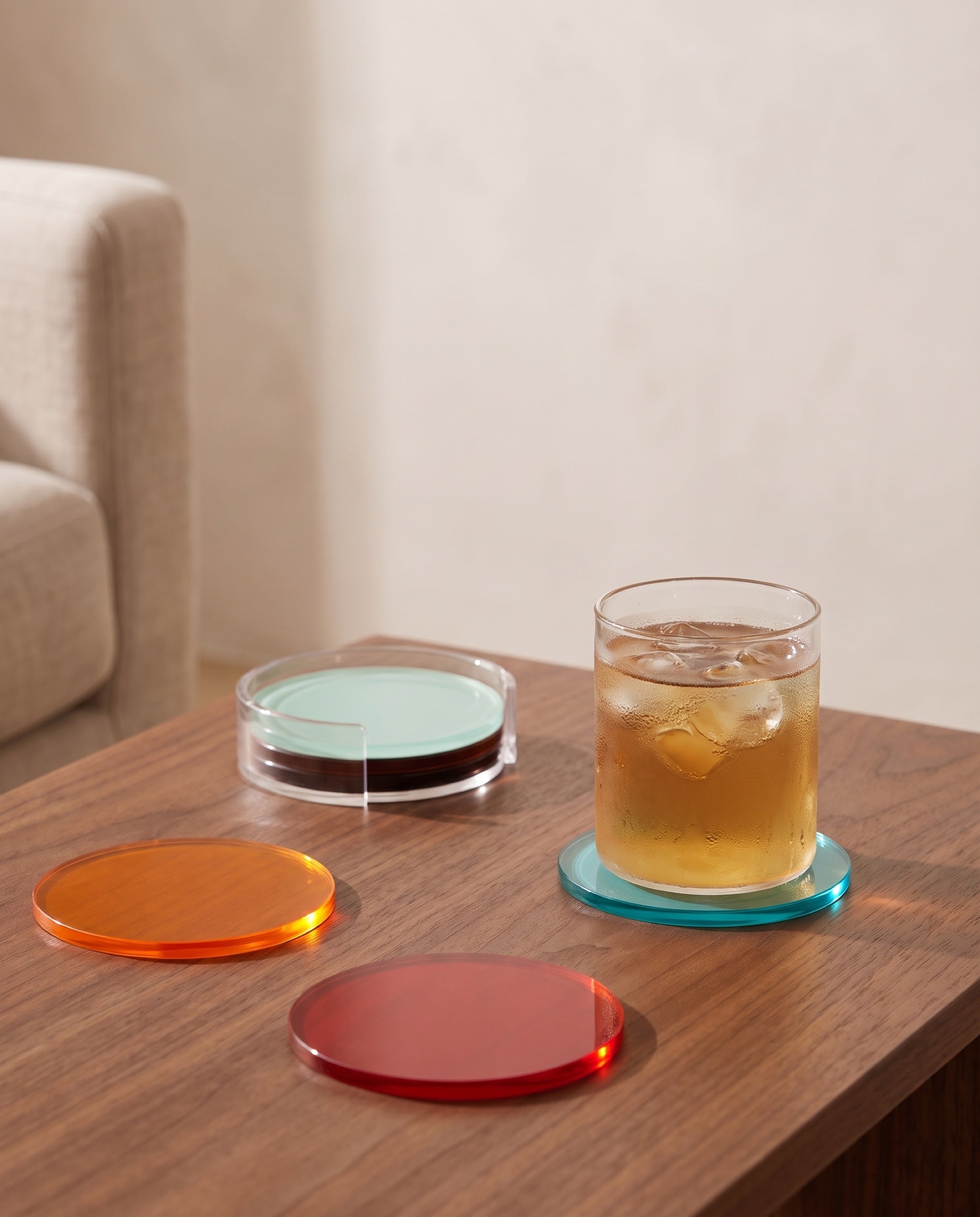 Rainbow coaster by APTONE, in use with a cold glass of barley tea, other discs out on the table
