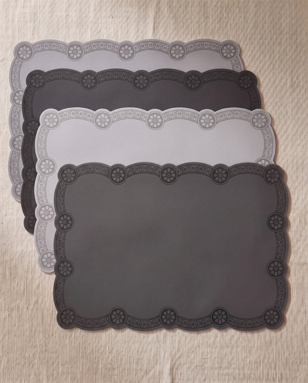 Roof tile silicone table mat set by Mimidar, four mats on beige linen, two light gray and two dark gray