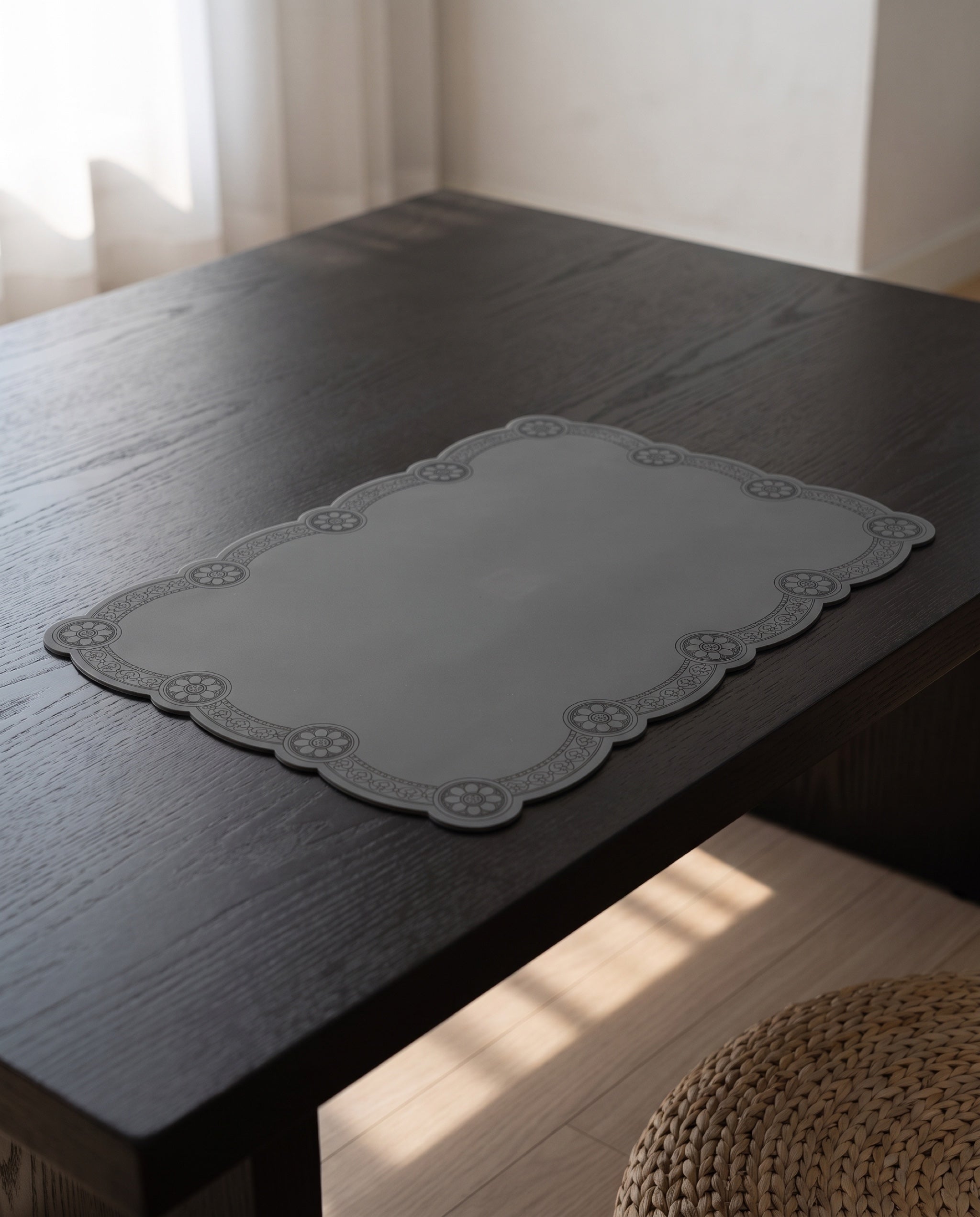 Roof tile silicone table mat by Mimidar, on a low dining table in dark-stained ash