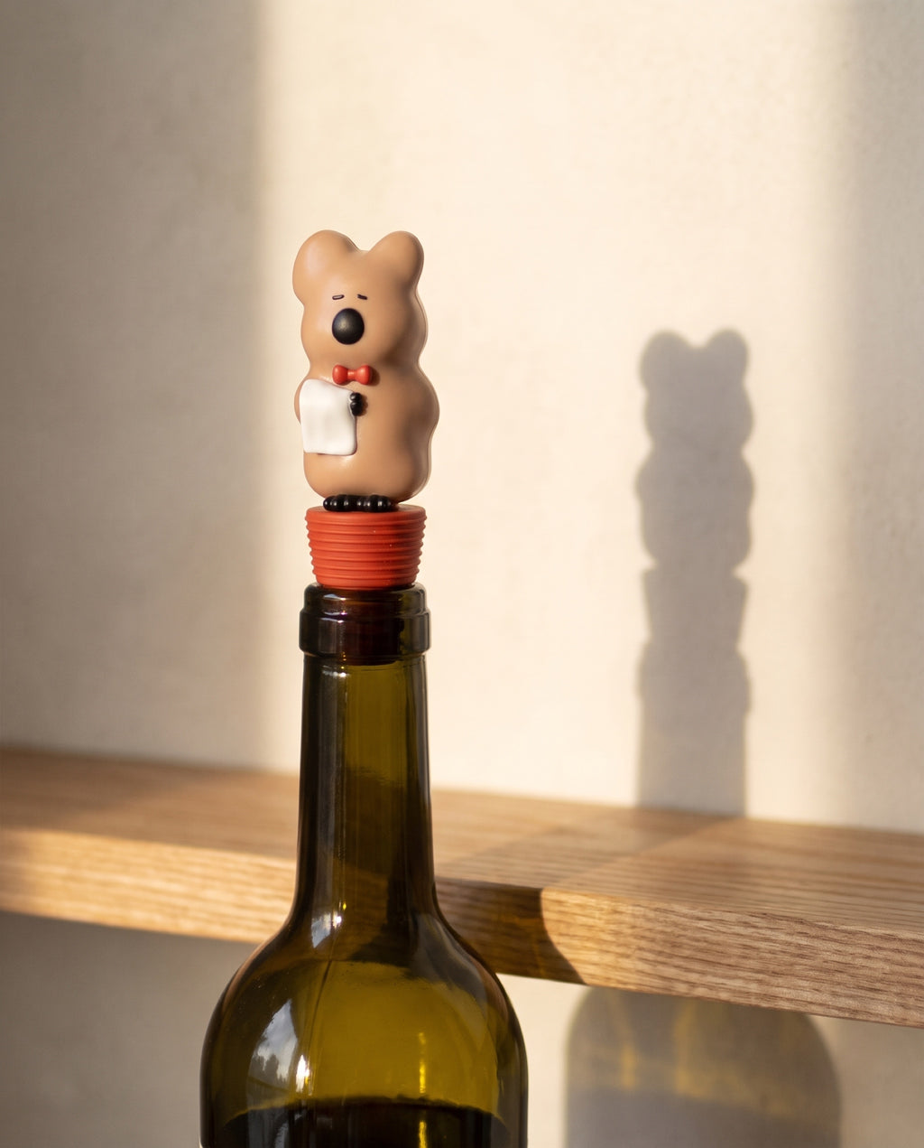 Quokka wine stopper by Dinotaeng, seated in the neck of an opened bottle