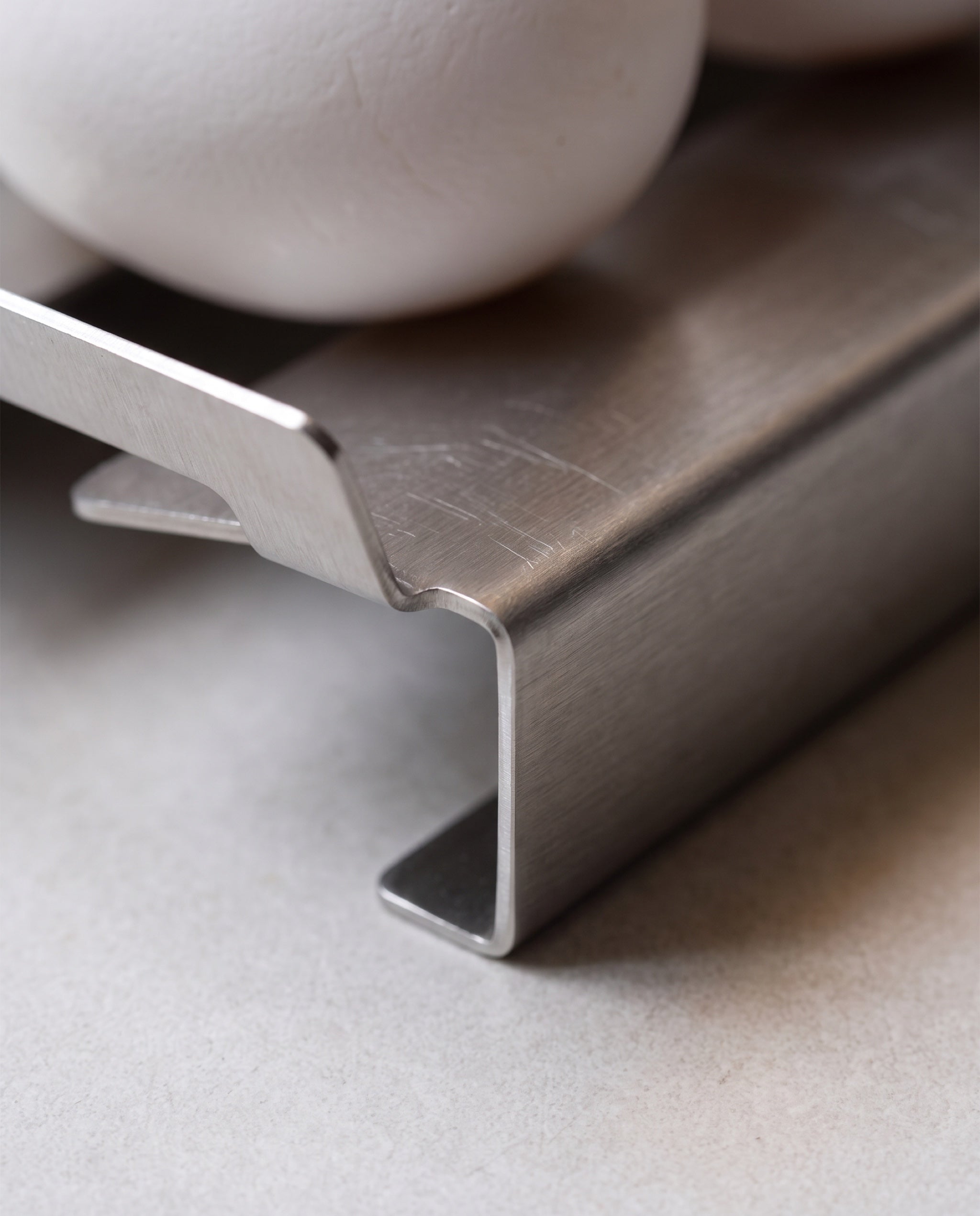 Slope egg tray by TactileEveryday, material detail at the folded edge and brushed grain
