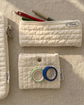 Quilted pencil case in soft cream, in use