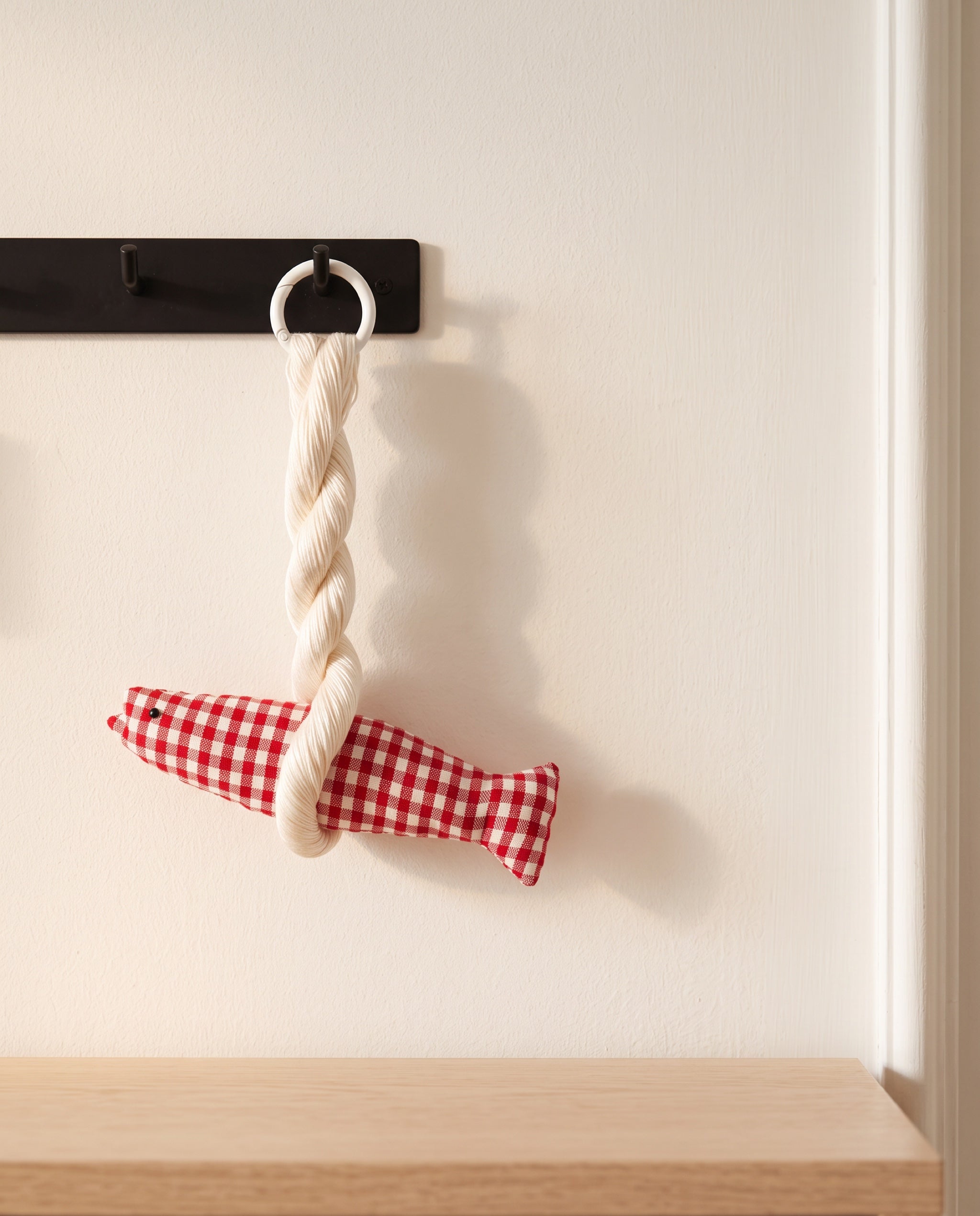 Big Colline good luck pollack ornament by lemonbaseball livingclub, the red one hanging from an entryway key rail